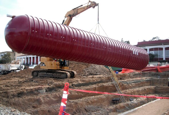 A 35,000-gallon tank is put into place next to a new general instruction building under construction at the Presidio of Monterey, Calif., March 25, 2013. The U.S. Army Corps of Engineers Sacramento District is overseeing construction of the building, which is designed to reach a silver rating under the Leadership in Energy and Environmental Design program. The 35,000-gallon tank will collect rain water from the building’s roof, which will then be used to help supply the building’s plumbing system. (U.S. Army Photo by Jack Davies/Released)