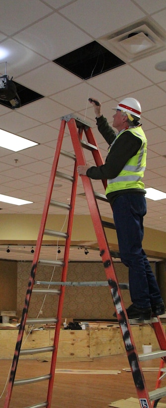 A Corps inspector inspects work being done inside the NCO Club.