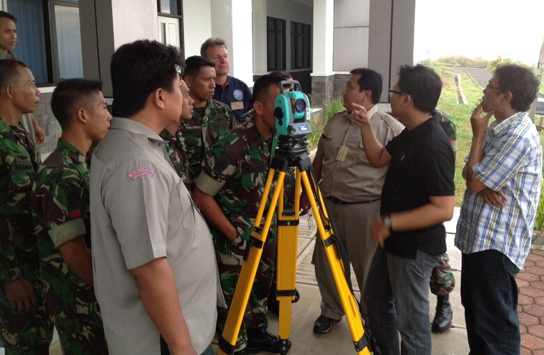 Tom Niedernhofer, U.S. Army Corps of Engineers Urban Searach and Rescue Program Manager, observes Indonesia participants test the use of survey equipment during the 2013 Indonesia Urban Search and Rescue Workshop. 
