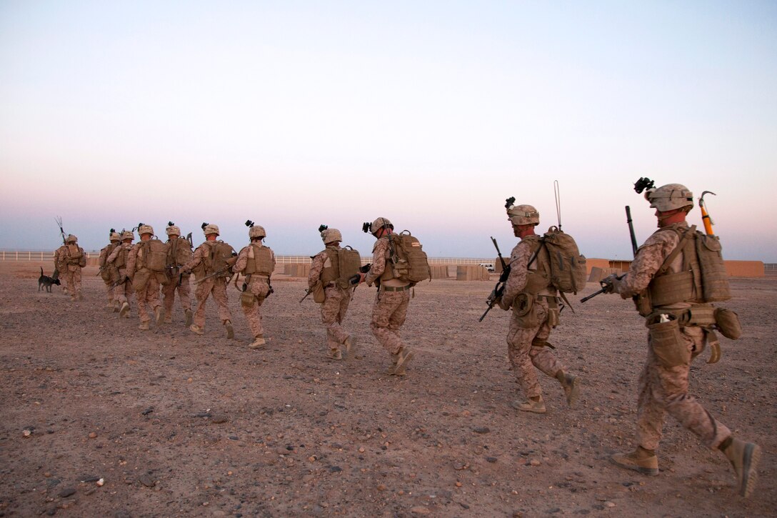 U.S. Marines move into position as they conduct a mission rehearsal on Camp Bastion in Helmand province, Afghanistan, May 27, 2013. The Marines and sailors, assigned to Fox Company, 2nd Battalion, 8th Marines, Regimental Combat Team 7, conducted the rehearsal in preparation for a partnered operation with Afghan soldiers.