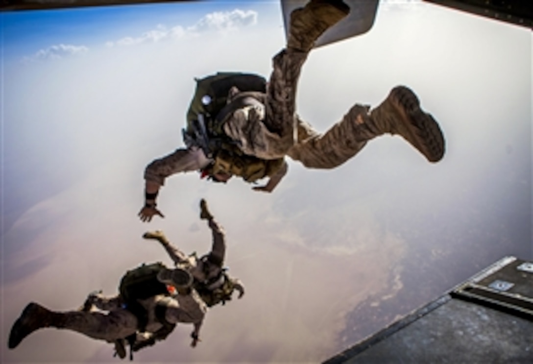 U.S. Marines exit the back of an MV-22B Osprey aircraft while conducting parachute operations over Djibouti, May 27, 2013. The Marines, assigned to the 26th Marine Expeditionary Unit, Maritime Raid Force Marines, are deployed to the U.S. 5th Fleet area of responsibility aboard the Kearsarge Amphibious Ready Group. The aircraft is assigned to Marine Medium Tiltrotor Squadon 266.