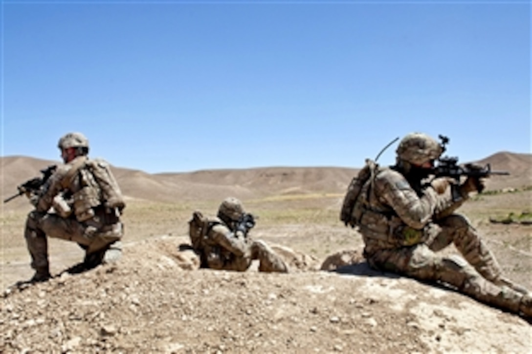 U.S. Army Sgt. Christopher Ross, right, U.S. Army Staff Sgt. Olin Harrington, center, and U.S. Army Spc. Jared Malda provide security for their team in Zabul province, Afghanistan, May 26, 2013. Ross, Harrington and Malda are assigned to the 2nd Infantry Division's 2nd Squadron, 1st Cavalry Regiment. Their unit participated in an Afghan-led search for weapon and explosive caches during a joint operation.