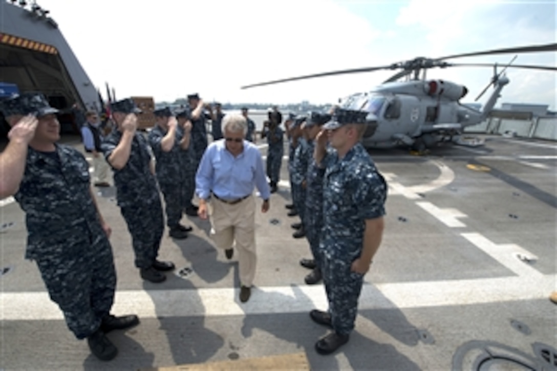 Secretary of Defense Chuck Hagel goes through the side boys as he leaves the USS Freedom (LCS 1) in Singapore on June 2, 2013.  Hagel toured the ship, visited with sailors and watched a demonstration of a reconfigurable and waterborne mission.  Freedom is the Navy’s first littoral combat ship and is forward deployed for operations out of Singapore.  