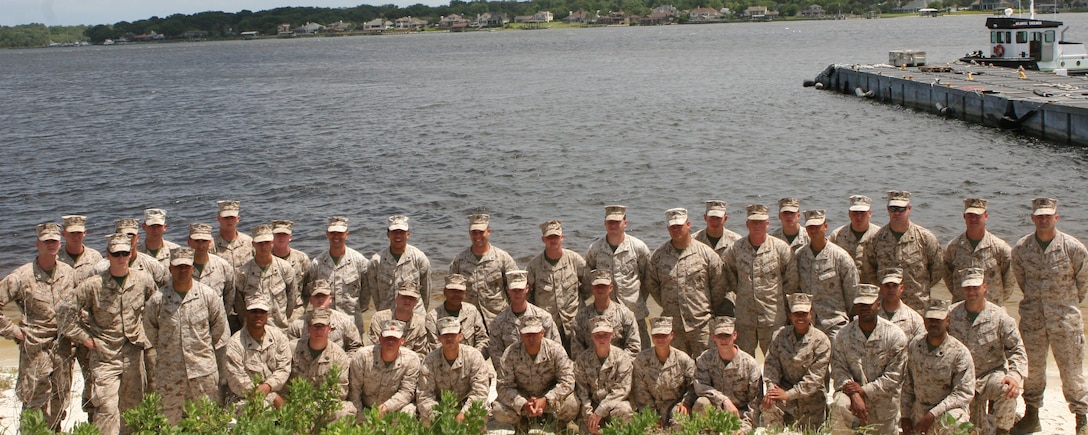 Service members from II Marine Expeditionary Force pose for a group photo aboard Marine Corps Support Facility Blount Island, Fla., May 29, 2013. The service members had just finished a 10-day Marine Prepositioning Force exercise where they learned the intricacies involved in prepositioning. (U.S. Marine Corps photo by Lance Cpl. Shawn Valosin)