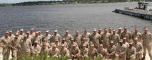 Service members from II Marine Expeditionary Force pose for a group photo aboard Marine Corps Support Facility Blount Island, Fla., May 29, 2013. The service members had just finished a 10-day Marine Prepositioning Force exercise where they learned the intricacies involved in prepositioning. (U.S. Marine Corps photo by Lance Cpl. Shawn Valosin)