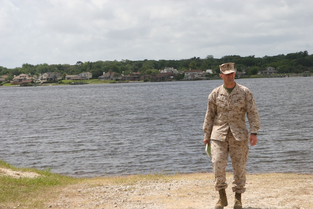 Maj. Daniel Bartos, the acting officer-in-charge of the Arrival and Assembly Operations Group, supervises service members while they clean a beach site during a Marine Prepositioning Force Exercise conducted aboard Marine Corps Support Facility Blount Island, Fla., May 22-30, 2013. Bartos said that when he heard about the possibility of conducting an MPF exercise, he couldn’t let the opportunity pass by. (U.S. Marine Corps photo by Lance Cpl. Shawn Valosin)