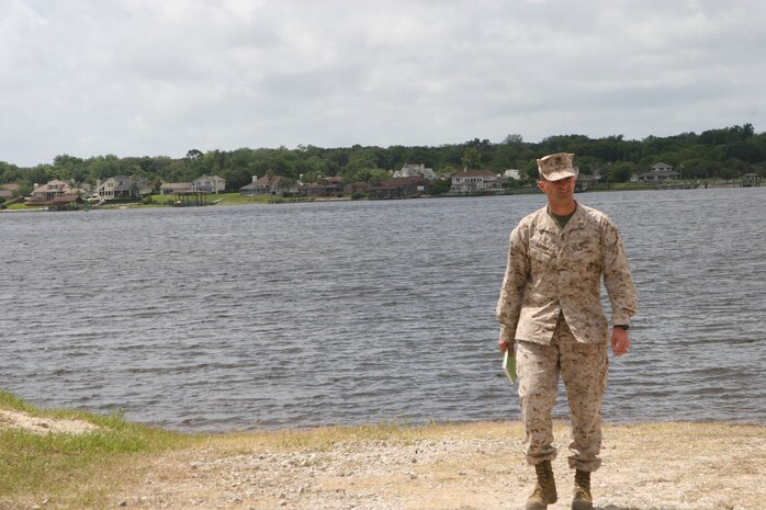 Maj. Daniel Bartos, the acting officer-in-charge of the Arrival and Assembly Operations Group, supervises service members while they clean a beach site during a Marine Prepositioning Force Exercise conducted aboard Marine Corps Support Facility Blount Island, Fla., May 22-30, 2013. Bartos said that when he heard about the possibility of conducting an MPF exercise, he couldn’t let the opportunity pass by. (U.S. Marine Corps photo by Lance Cpl. Shawn Valosin)