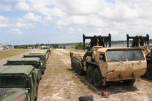 Vehicles lay in wait for more cargo and personnel during a Marine Prepositioning Force Exercise conducted by service members from the II Marine Expeditionary Force and Navy Beach Master Unit Two aboard Marine Corps Support Facility Blount Island, Fla., May 28, 2013. The exercise was used to re-certify sailors from BMU2 as well as prepare the II MEF service members for a larger exercise scheduled to take place next year.