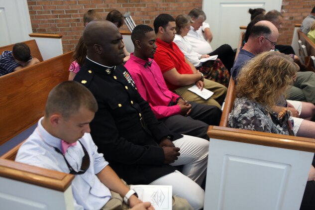 Maj. LeRon E. Lane, the Assistant Chief of Staff G-6 with 2nd Marine Logistics Group, closes his eyes during a prayer at the Christian Home School Association graduation in Rocky Mount, N.C., June 1, 2013. Lane came to the graduation to watch Steven C. James graduate after receiving five heart surgeries in his lifetime.