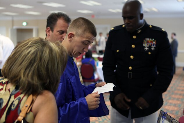 Maj. LeRon E. Lane, a Cherry Point, N.C., native and the Assistant Chief of Staff G-6, 2nd Marine Logistics Group, presents letters from the 2nd MLG to Steven C. James, a Nashville, N.C., native, during the Christian Home School Association graduation in Rocky Mount, N.C., June 1, 2013. In 2012, James visited Camp Lejeune and was hosted by Marines and sailors with the 2nd MLG to sit in tanks, hold weapons, sit in the base commanding general’s chair and perform a Marine Corps Combat Fitness Test. 