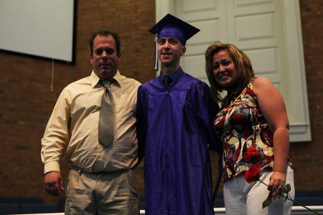 Steven C. James, a Nashville, N.C., native, poses with his father, Larry, and his mother, Michelle, as he receives his graduation certificate from the Christian Home School Association in Rocky Mount, N.C., June 1, 2013. All Steven wants to be is a Marine but with five heart surgeries, he is not eligible for enlistment He received physical and moral support from the Marines and sailors with 2nd Marine Logistics Group during a visit to Camp Lejeune in 2012. 