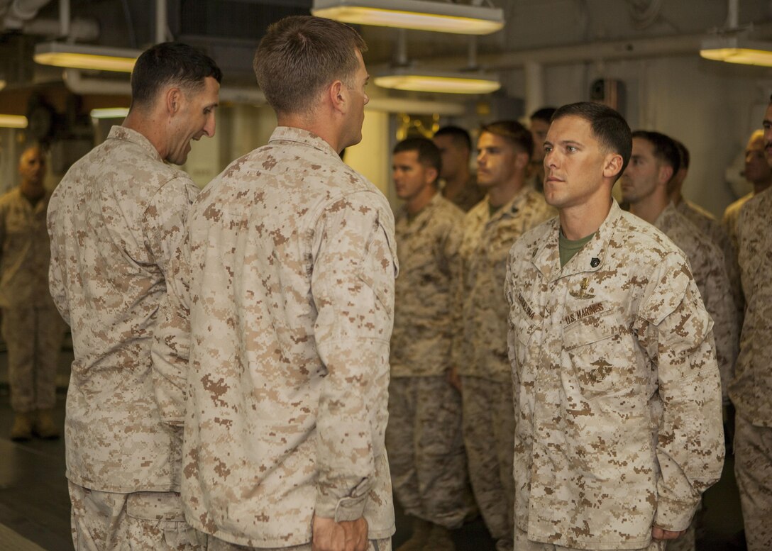 U.S. Marine Staff Sgt. Nicholas Barcelona, a team leader assigned to Maritime Raid Force, 26th Marine Expeditionary Unit (MEU) is awarded a Navy and Marine Corps Achievement Medal with combat distinguishing device for actions during his previous deployment in Afghanistan, aboard USS Kearsarge (LHD 3), at sea, June 4, 2013. The 26th MEU is a Marine Air-Ground Task Force forward-deployed to the U.S. 5th Fleet area of responsibility aboard the Kearsarge Amphibious Ready Group serving as a sea-based, expeditionary crisis response force capable of conducting amphibious operations across the full range of military operations. (U.S. Marine Corps photo by Sgt. Christopher Q. Stone, 26th MEU Combat Camera/Released)