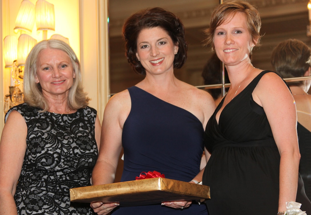 Jamie Weathers, center, a music teacher with Saint Francis of Assisi Catholic School, Ariz., and a Marshall, Okla., native, stands with Jeanie Spies, the Flying Leatherneck Historical Foundation committee chairman, and Sasha Lightfoot, last year’s Irene Ferguson Marine Wife Recognition Award recipient, after receiving her award at the 8th Annual Flying Leatherneck Historical Foundation Black Tie Gala at the Westgate Hotel, San Diego, June 1. Weathers is this year’s recipient of the award in recognition of her exceptional support of the military and her community.  