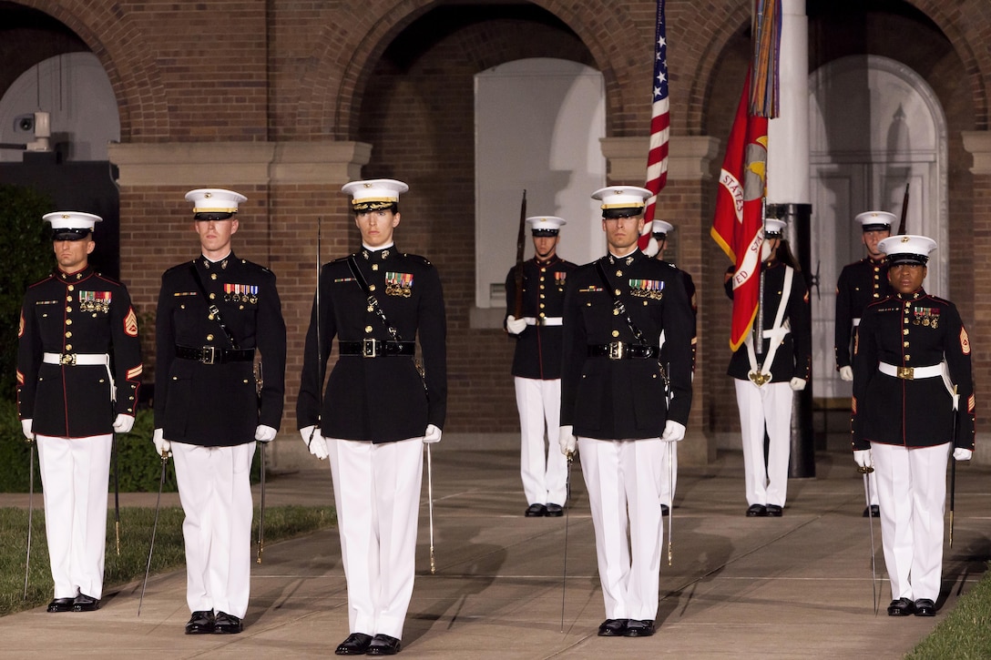 A parade staff with Marine Barracks Washington, D.C., stands in their position during a Friday Evening Parade at the Barracks May 31. 