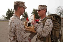 Recruiting Station Twin Cities' Sgt. Maj. Sean P. Cox presents the Gung Ho Award to Recruiting Substation's Sgt. Nicholas Bynum during the mini boot camp closing ceremony April 28. More than 650 aspiring Marines and guests attended the event. For additional imagery from the event, visit www.facebook.com/rstwincities.  