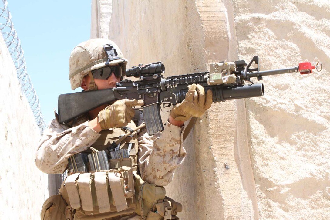 Lance Cpl. Jeremy Jongekryg, a rifleman serving with Fox Company, 2nd Battalion, 1st Marine Regiment, maneuvers around a building to capture an enemy role player during Military Operations on Urban Terrain training at the Infantry Immersion Trainer here, May 29, 2013. Jongekryg, 21, from Green Rapids, Michigan, captured the role player after finding him hiding inside a local shop.