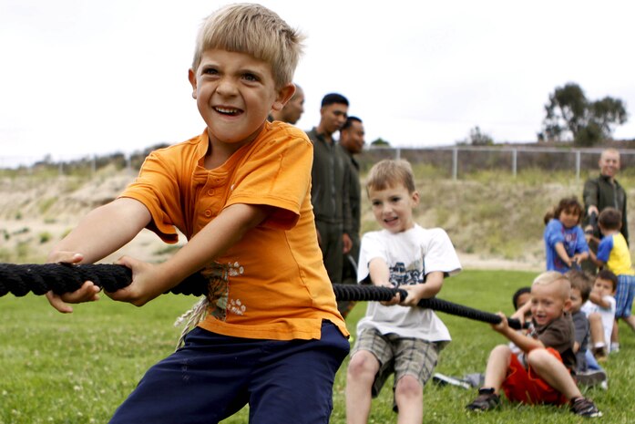 Gunnar, 5, fights to help his fellow classmates win the “boys-against-girls” tug of war competition at San Onofre Elementary School here during the Physical Training Fitness Challenge June 4. More than 30 Marines from the Single Marine Program here volunteered to mentor the kindergarten through 8th grade children during their recess.