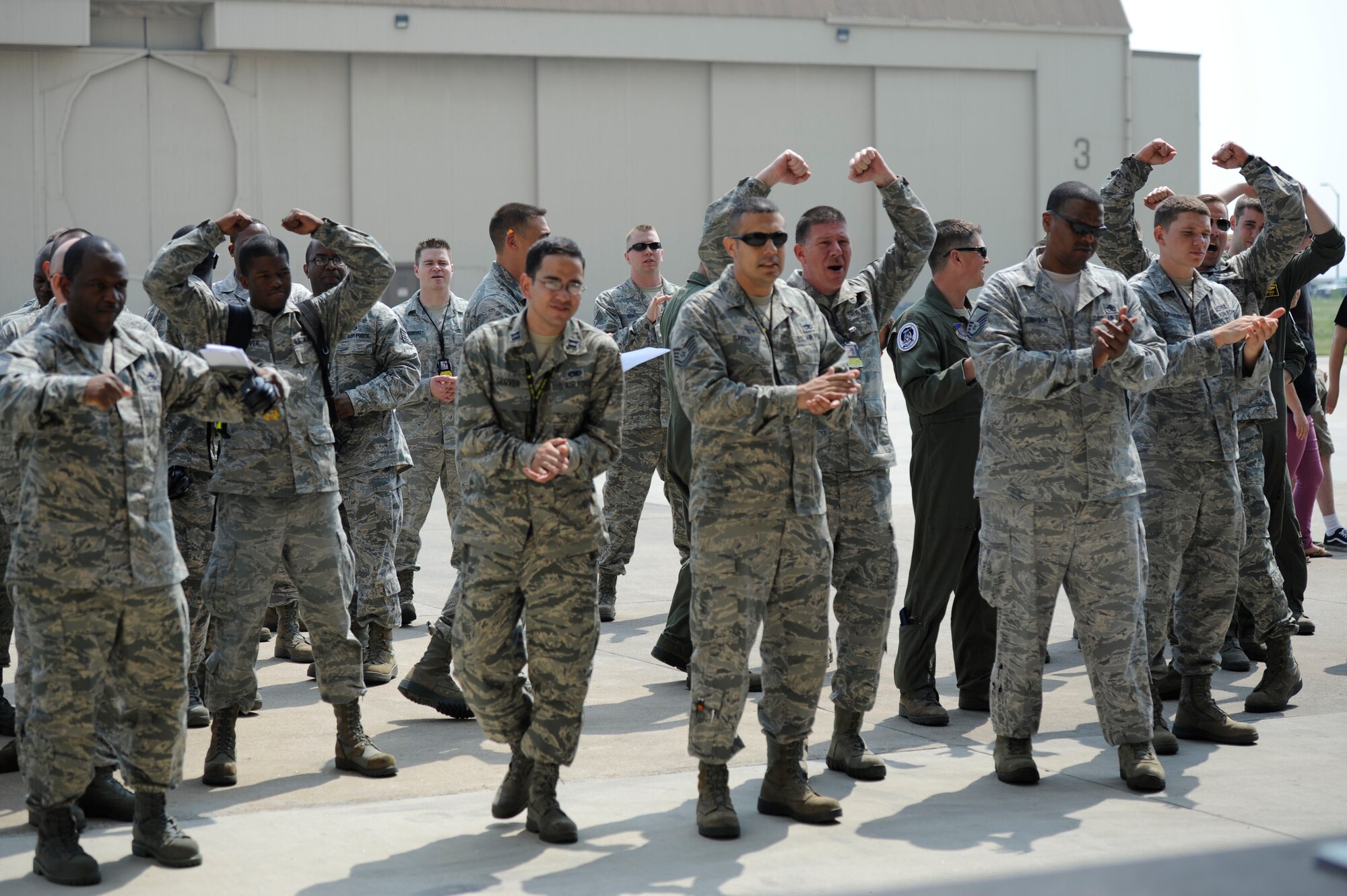 KUNSAN AIR BASE, Republic of Korea – 80th Fighter Squadron members throw up the “Crush’em” sign after their weapons load crew completes the bomb loading portion of the competition at Kunsan Air Base Republic of Korea, May 23, 2013. Weapons load competitions are held quarterly and allowed teams to see who the best was for each quarter. (U.S. Air Force photo by Staff Sgt. Tong Duong/ Released) 