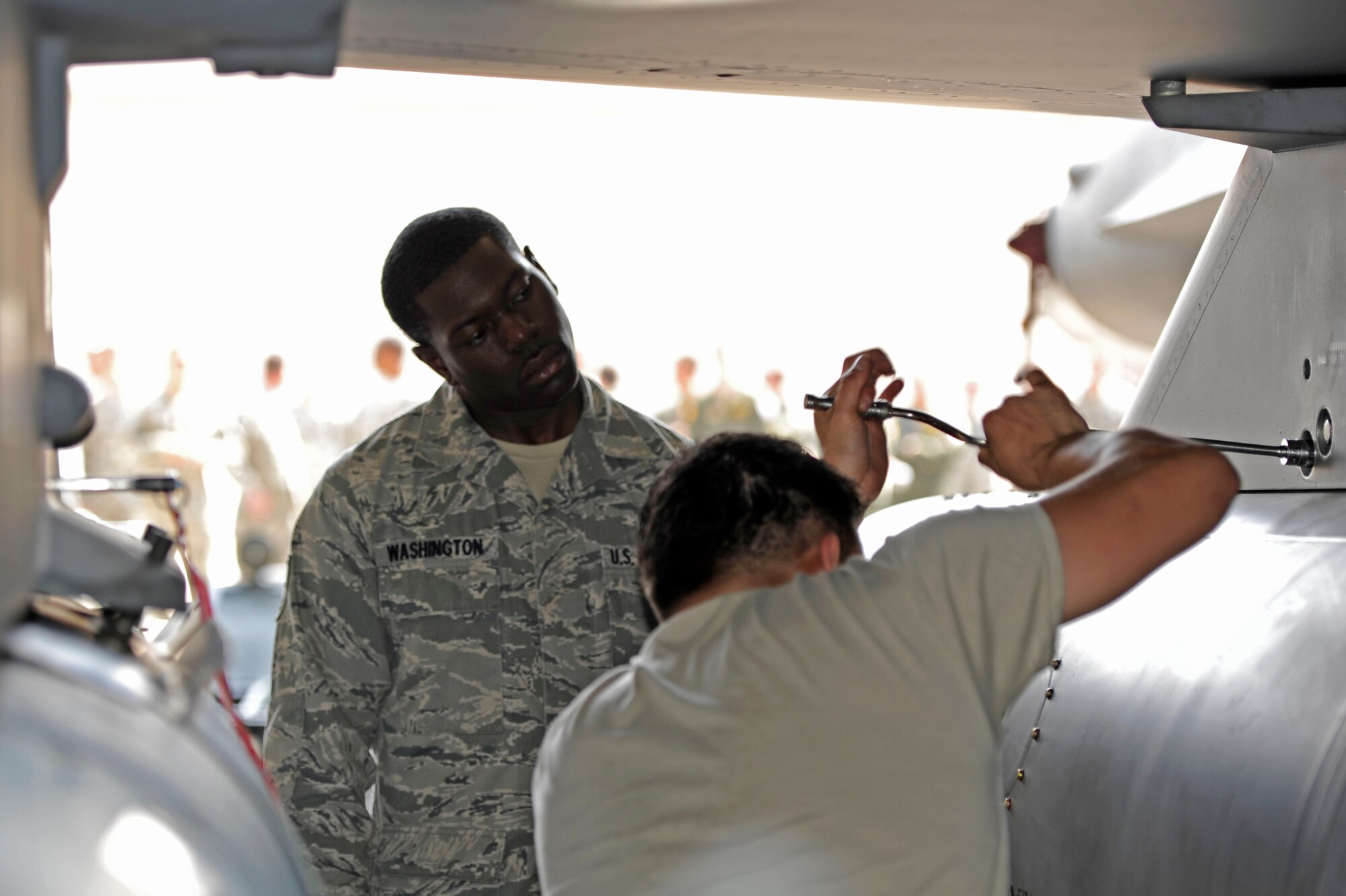 KUNSAN AIR BASE, Republic of Korea – Senior Airman Gregory Washington, 8th Maintenance Operations Squadron load barn weapons standardization inspector, observes Senior Airman Enrique Melgarejo, 80th Aircraft Maintenance Unit crew chief, during a load crew competition at Kunsan Air Base Republic of Korea, May 23, 2013. More than 70 Wolf Pack Airmen and leadership watched as crew chiefs from the 80th and 35th AMU’s competed for the chance to represent Kunsan during the next peninsula wide load crew competition. (U.S. Air Force photo by Staff Sgt. Tong Duong/ Released) 
