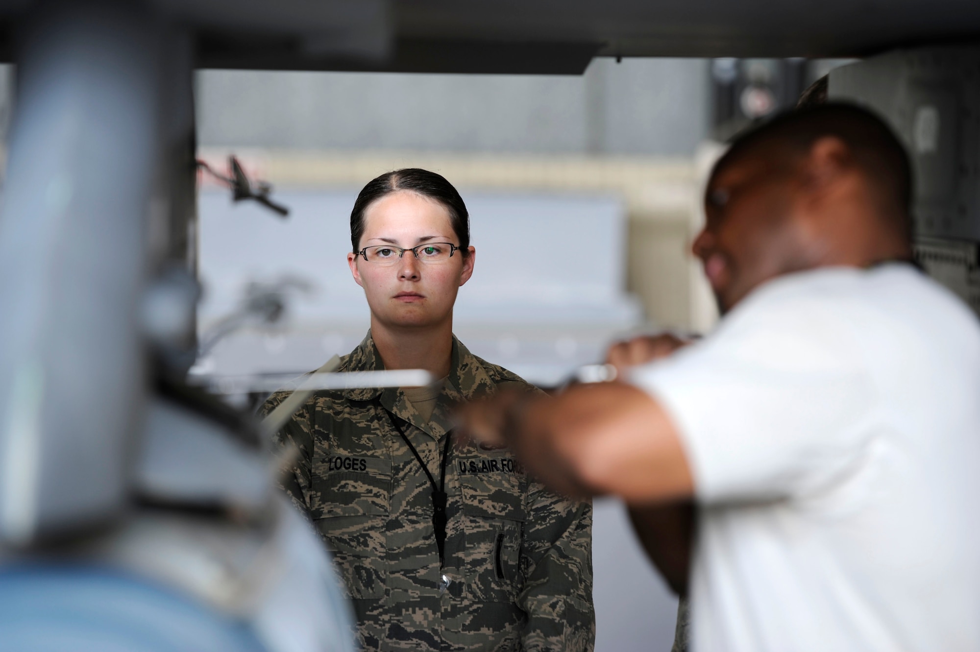 KUNSAN AIR BASE, Republic of Korea – Senior Airman Cecil Loges, 8th Maintenance Operations Squadron load barn weapons standardization inspector, observes Senior Airman Damon Bryant, 80th Aircraft Maintenance Unit crew chief, during a load crew competition at Kunsan Air Base Republic of Korea, May 23, 2013. Inspectors like Loges ensured weapons were loaded safely, while also checking crew chiefs for technical proficiency and reliabilities. (U.S. Air Force photo by Staff Sgt. Tong Duong/ Released) 
