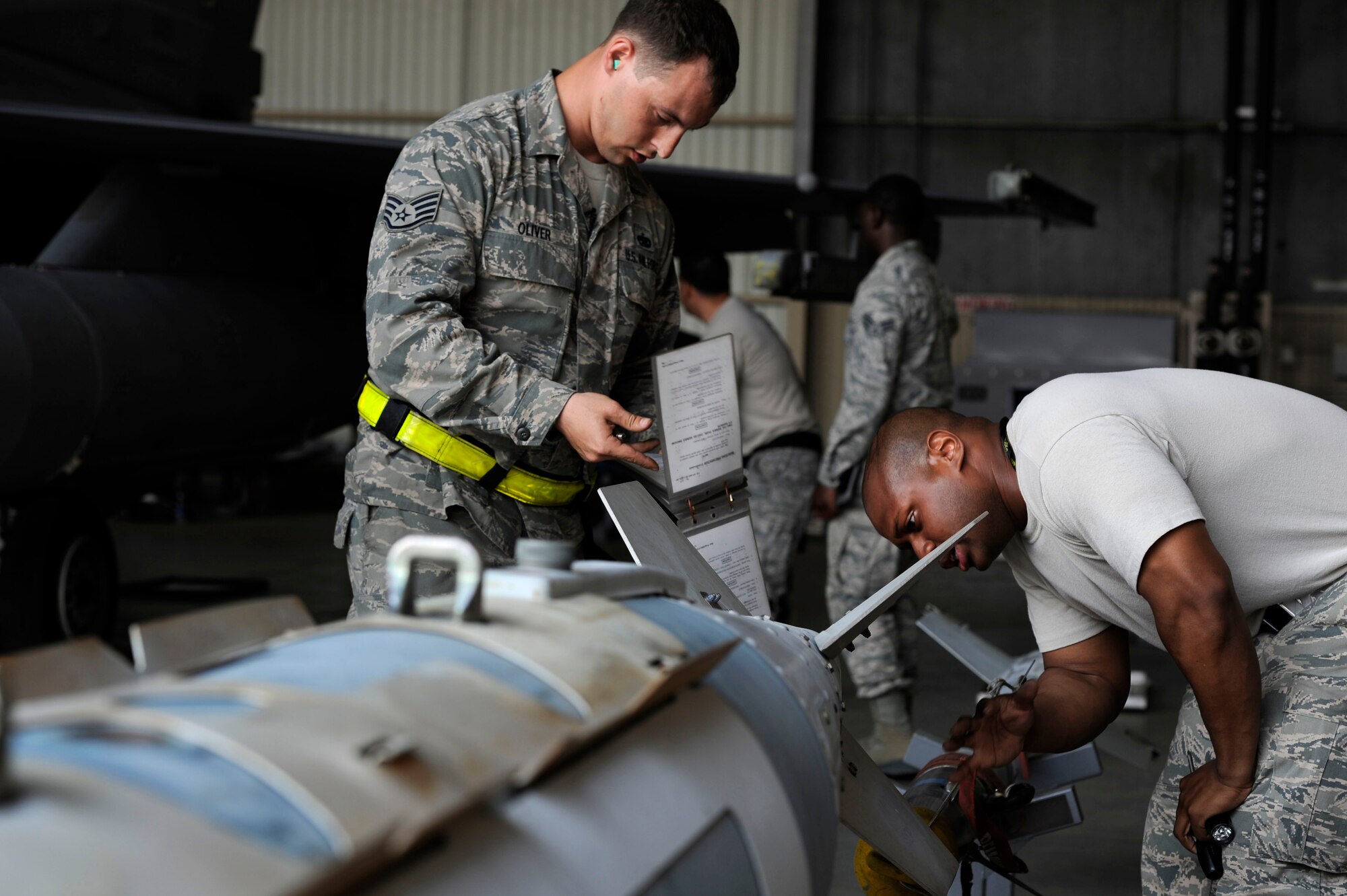 KUNSAN AIR BASE, Republic of Korea – 80th Aircraft Maintenance Unit crew chiefs, Staff Sgt. Jonathan Oliver, team chief, left, and Senior Airman Damon Bryant, three-man, inspect a GBU-31 version 1 Joint Direct Attack Munition, during a load crew competition at Kunsan Air Base Republic of Korea, May 23, 2013. The competition allowed teams to see who the ‘best of the best’ was for the quarter. (U.S. Air Force photo by Staff Sgt. Tong Duong/ Released) 