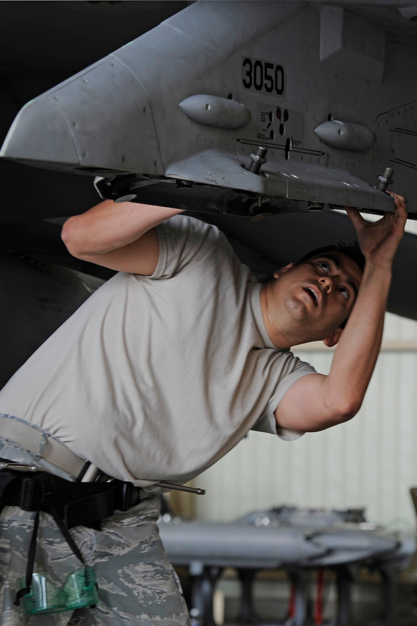 KUNSAN AIR BASE, Republic of Korea – Senior Airman Enrique Melgarejo, 80th Aircraft Maintenance Unit crew chief, inspects an F-16 Fighting Falcon during the second quarter load crew competition at Kunsan Air Base Republic of Korea, May 23, 2013. The weapons load crew comprised of a team chief, a two-man and the three-man, and Melgarejo, is in the two-man position. (U.S. Air Force photo by Staff Sgt. Tong Duong/ Released) 