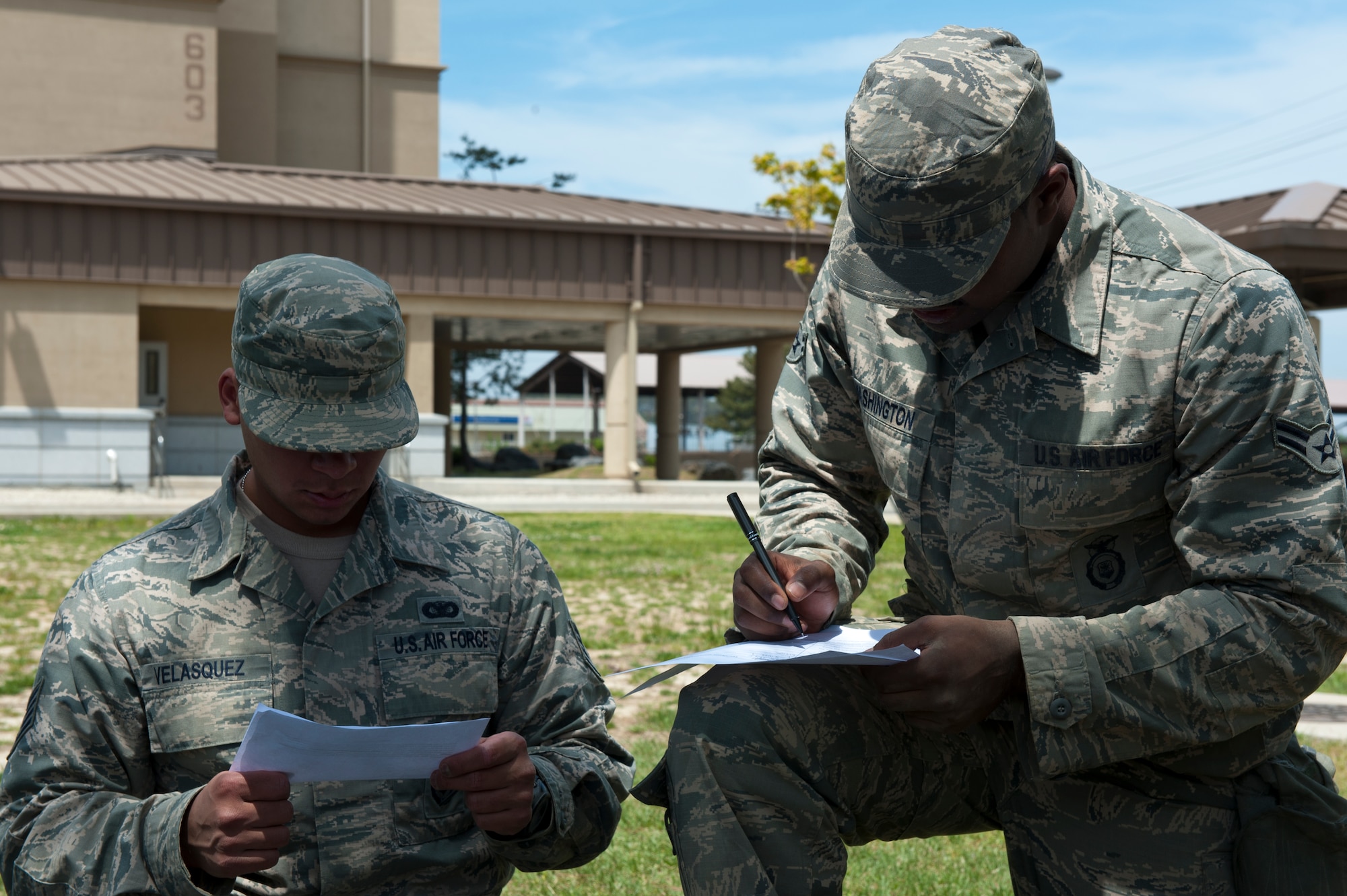 Staff Sgt. Luis Velasquez, left, and Airman 1st Class Raymond Washington, 8th Security Forces Squadron members, fill out a 9-line medical evacuation form during a defenders’ challenge at Kunsan Air Base, Republic of Korea, May 17, 2013. The event tested their ability to respond to a specific scenario and accurately report what was needed for a medical evacuation. (U.S. Air Force photo by Staff Sgt. Jonathan Fowler/Released)