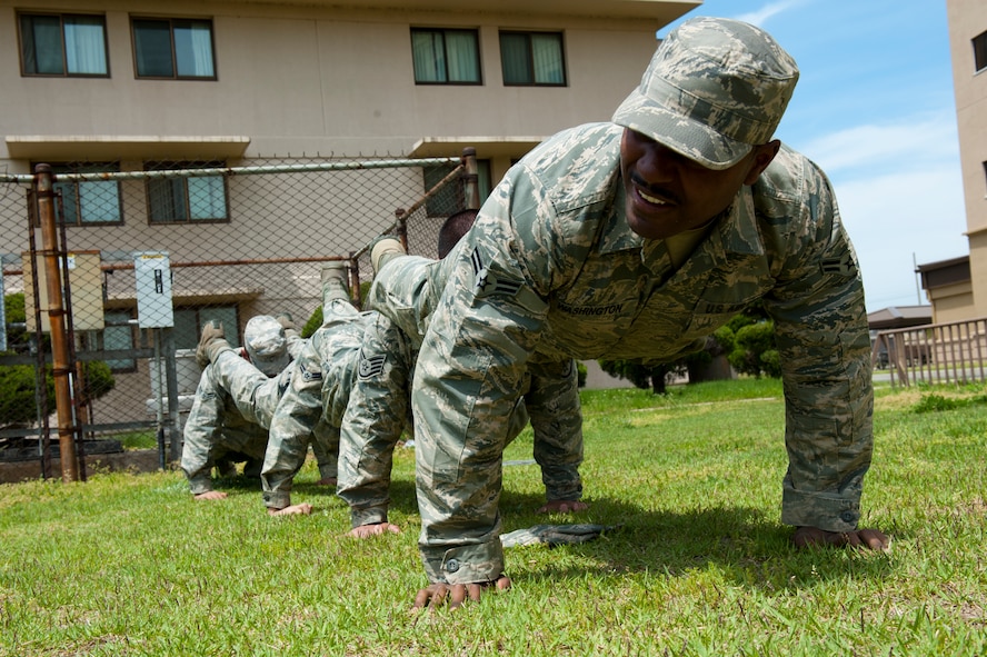 8th Security Forces Squadron Bravo flight members perform “ranger” push-ups during a defenders’ challenge at Kunsan Air Base, Republic of Korea, May 17, 2013. The challenge was the last event held by the 8th SFS during National Police Week, May 12-18, which honors fallen defenders and law enforcement members. (U.S. Air Force photo by Staff Sgt. Jonathan Fowler/Released)