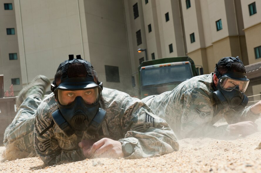 Staff Sgt. Luis Velasquez, left, and Airman 1st Class Edmund Oropeza, 8th Security Forces Squadron members, high crawl while wearing gas masks at Kunsan Air Base, Republic of Korea, May 17, 2013. This event was part of a special National Police Week defenders’ challenge that tested their strength and endurance. (U.S. Air Force photo by Staff Sgt. Jonathan Fowler/Released)