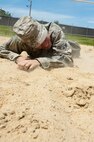 Airman 1st Class Edmund Oropeza, 8th Security Forces Squadron, low crawls during a defenders’ challenge event at Kunsan Air Base, Republic of Korea, May 17, 2013. Oropeza and other members of the 8th SFS Bravo flight competed in six different events which included pushing a Humvee and issuing a 9-line medical evacuation order. (U.S. Air Force photo by Staff Sgt. Jonathan Fowler/Released)