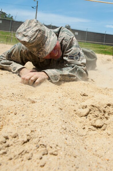 Airman 1st Class Edmund Oropeza, 8th Security Forces Squadron, low crawls during a defenders’ challenge event at Kunsan Air Base, Republic of Korea, May 17, 2013. Oropeza and other members of the 8th SFS Bravo flight competed in six different events which included pushing a Humvee and issuing a 9-line medical evacuation order. (U.S. Air Force photo by Staff Sgt. Jonathan Fowler/Released)