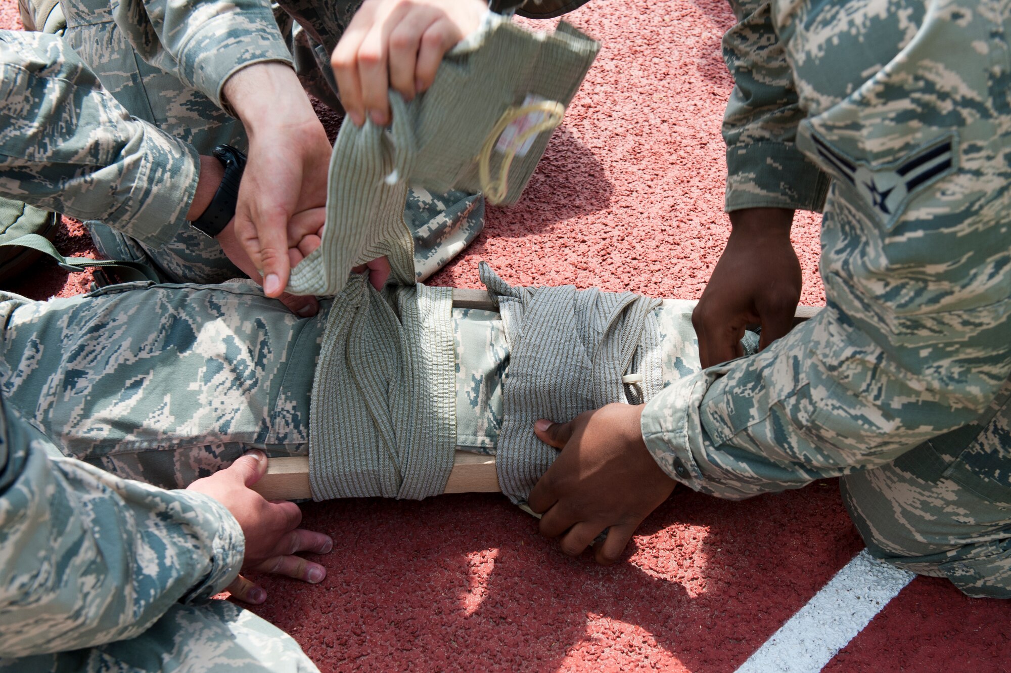 8th Security Forces Squadron Bravo flight members complete the self-aid and buddy care portion of the defenders’ challenge event at Kunsan Air Base, Republic of Korea, May 17, 2013. Each event of the challenge tested different abilities and skills that security forces members may use in a real world event. (U.S. Air Force photo by Staff Sgt. Jonathan Fowler/Released)