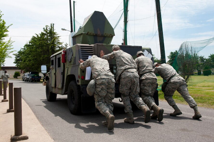 8th Security Forces Squadron Bravo flight members push an 11,500 pound Humvee at Kunsan Air Base, Republic of Korea, May 17, 2013. The event was part of a special defenders’ challenge which honored National Police Week, May 12 to 18. (U.S. Air Force photo by Staff Sgt. Jonathan Fowler/Released)