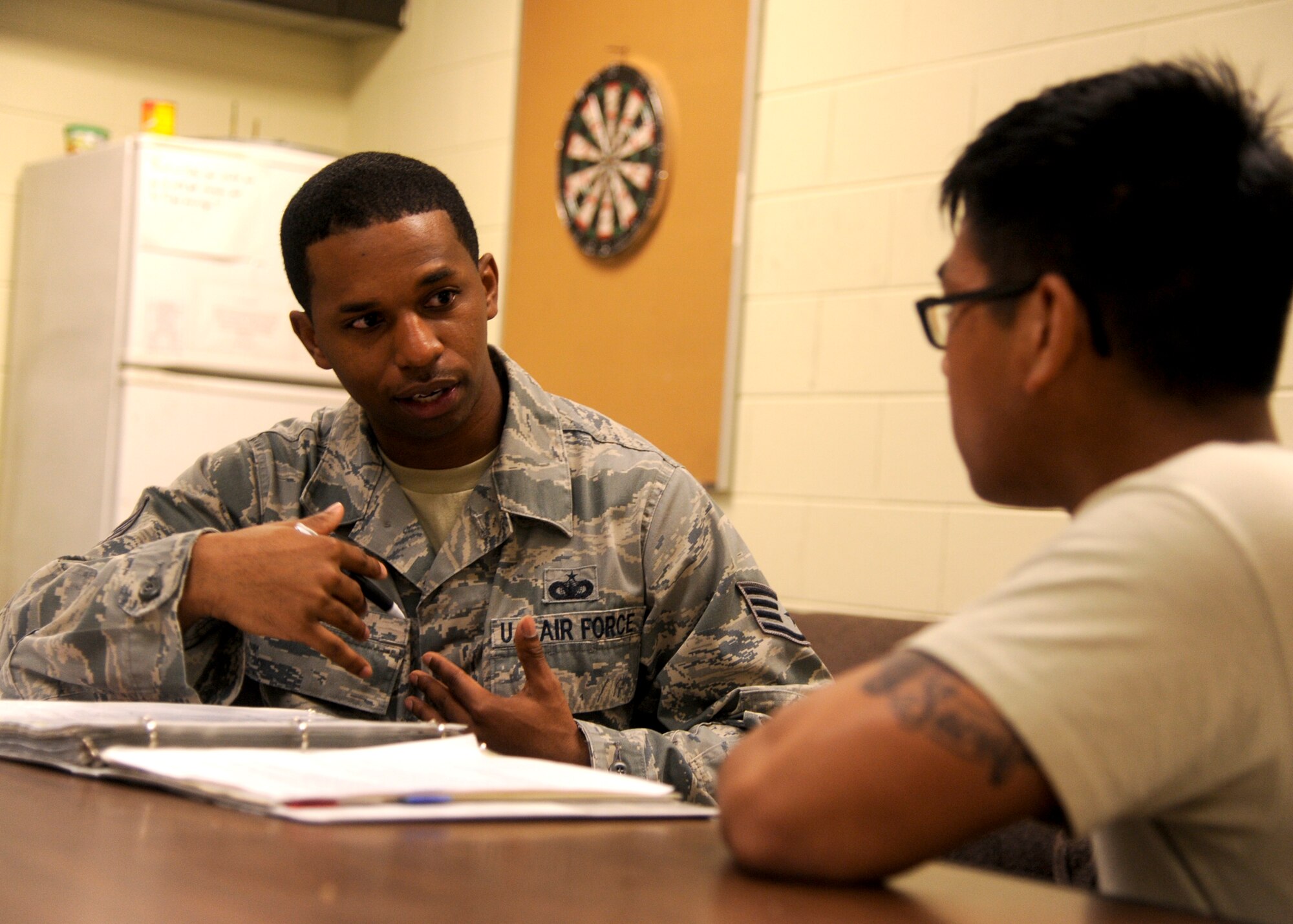 KUNSAN AIR BASE, Republic of Korea -- Staff Sgt. Jeffery Self, 8th Security Forces Squadron resource protection NCO in charge, reviews operation instructions with an Airman at Kunsan Air Base, Republic of Korea, May 28, 2013. Self was named Kunsan’s “Pride of the Pack” winner May 24 to 29. (U.S. Air Force photo by Senior Airman Jessica Haas/Released)