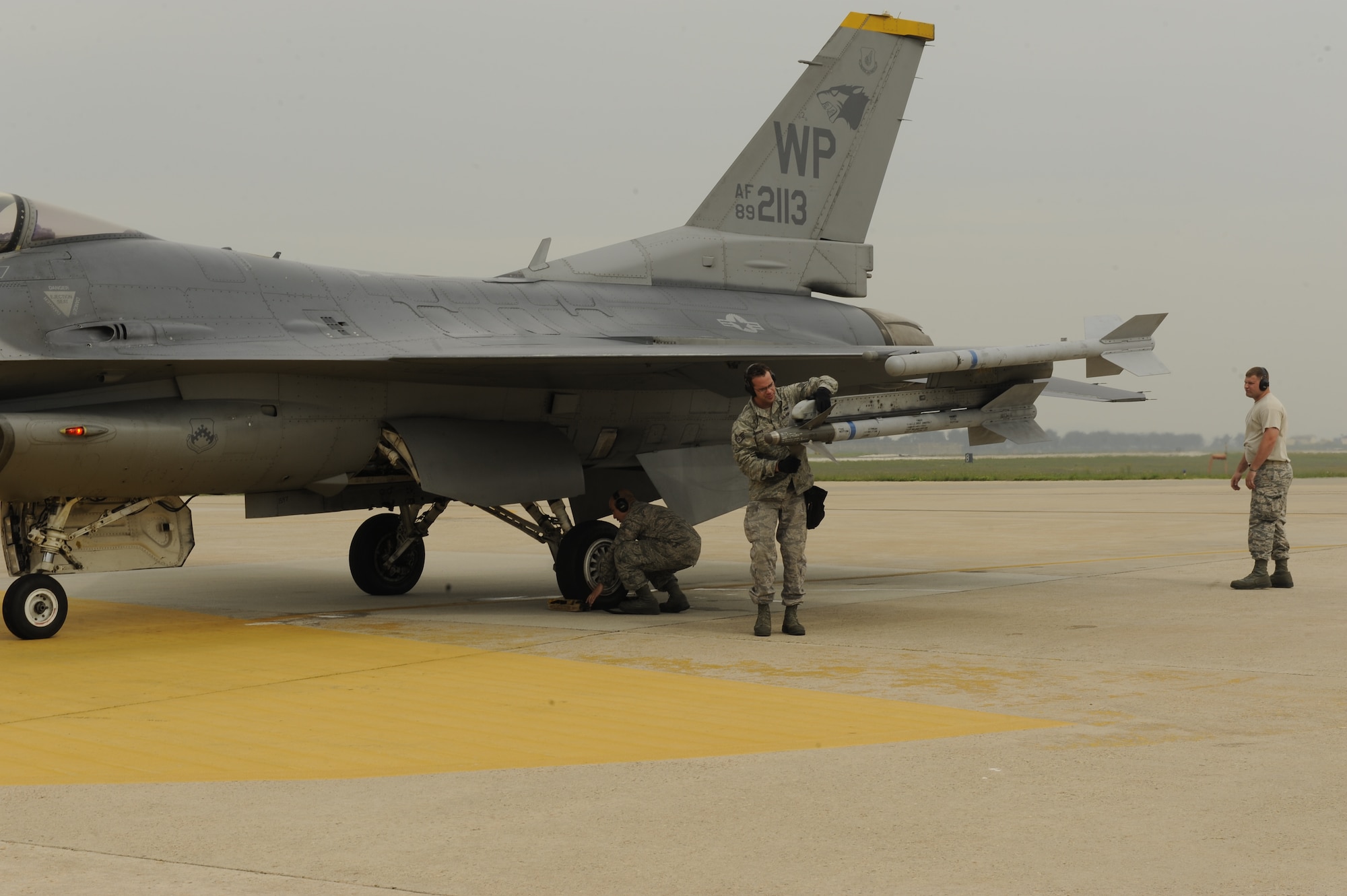 Airmen from the 8th Aircraft Maintenance Squadron conduct a final check on an F-16 Fighting Falcon during a large formation exercise at Kunsan Air Base, Republic of Korea, May 31, 2013. More than 30 F-16 Fighting Falcon pilots participated in the exercise, which featured numerous scenarios designed to test and hone their skills and abilities. (U.S. Air Force photo by Senior Airman Marcus Morris/Released)