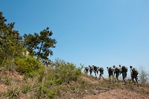 8th Security Forces Squadron defenders finish the last leg of a ruck march at Kunsan Air Base, Republic of Korea, May 13, 2013. The march took security forces members from their main work center to the highest point of the base. (U.S. Air Force photo by Staff Sgt. Jonathan Fowler/Released)