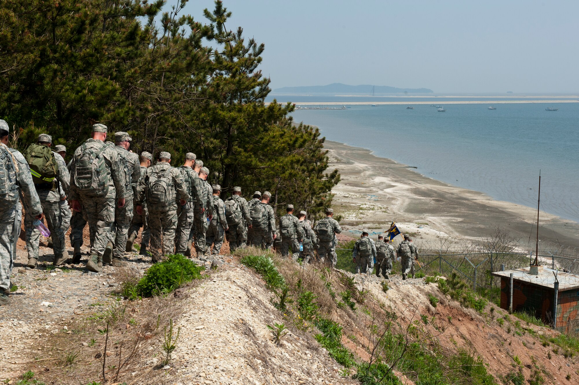 8th Security Forces Squadron defenders march down a hill during a ruck march at Kunsan Air Base, Republic of Korea, May 13, 2013. The march was designed to boost morale and fellowship amongst security forces members. (U.S. Air Force photo by Staff Sgt. Jonathan Fowler/Released)
