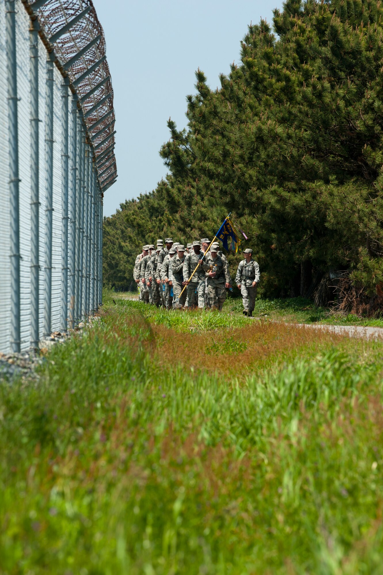 8th Security Forces Squadron defenders march by the perimeter fence at Kunsan Air Base, Republic of Korea, May 13, 2013. The march was part of a number of events which honored National Police Week. (U.S. Air Force photo by Staff Sgt. Jonathan Fowler/Released)