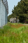 8th Security Forces Squadron defenders march by the perimeter fence at Kunsan Air Base, Republic of Korea, May 13, 2013. The march was part of a number of events which honored National Police Week. (U.S. Air Force photo by Staff Sgt. Jonathan Fowler/Released)