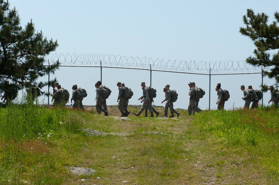 8th Security Forces Squadron defenders participate in a march at Kunsan Air Base, Republic of Korea, May 13, 2013. The defenders carried their ruck sacks and gear for more than three miles along the perimeter of the base. (U.S. Air Force photo by Staff Sgt. Jonathan Fowler/Released)
