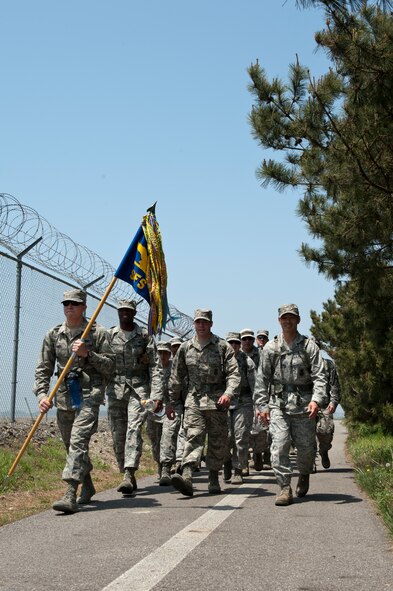 8th Security Forces Squadron defenders march along the perimeter of Kunsan Air Base, Republic of Korea, May 13, 2013. This was part of the 8th SFS National Police Week events, which featured a ruck march and a defenders’ challenge. (U.S. Air Force photo by Staff Sgt. Jonathan Fowler/Released)