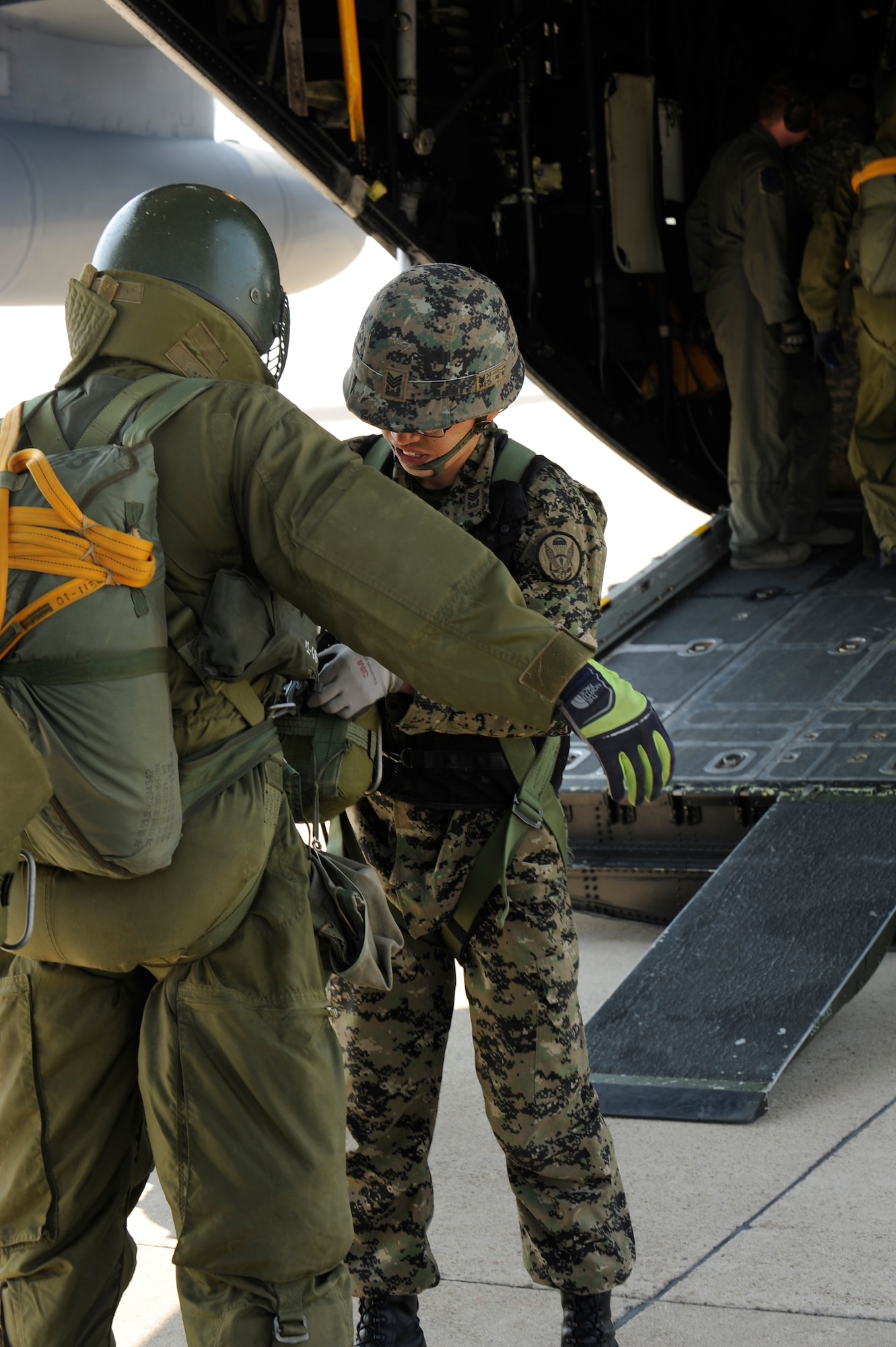 Republic of Korea army 7th Special Forces Brigade, 35th Special Forces Battalion soldiers do a final operations check on gear before they enter a MC-130P Combat Shadow from Kadena Air Base, Japan for jump training at Kunsan Air Base, Republic of Korea, April 4, 2013. This was an annual FOAL Eagle exercise designed to enhance readiness and the ability to respond to any potential contingency that might arise. (U.S. Air Force photo by Senior Airman Marcus Morris/Released)