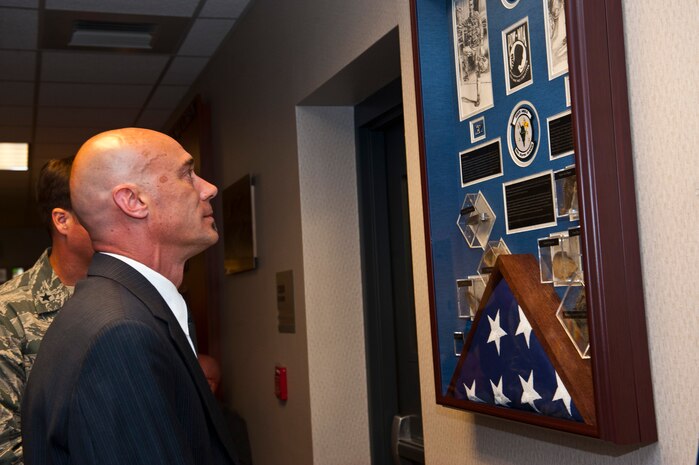 Michael Keller, son of Col. Wendell Keller, views the memorial shadowbox of his father and Capt. Virgil Meroney during the 433rd Weapons Squadron heritage hall dedication ceremony May 23, 2013, at the U.S. Air Force Weapons School on Nellis Air Force Base, Nev. Keller and Meroney were tasked with a night interdiction mission against a heavily defended supply route and storage area complex near the Ban Karai Pass March 1, 1969. During this mission, they came under fire and were reported missing in action by the Department of Defense. (U.S. Air Force photos by Senior Airman Brett Clashman)