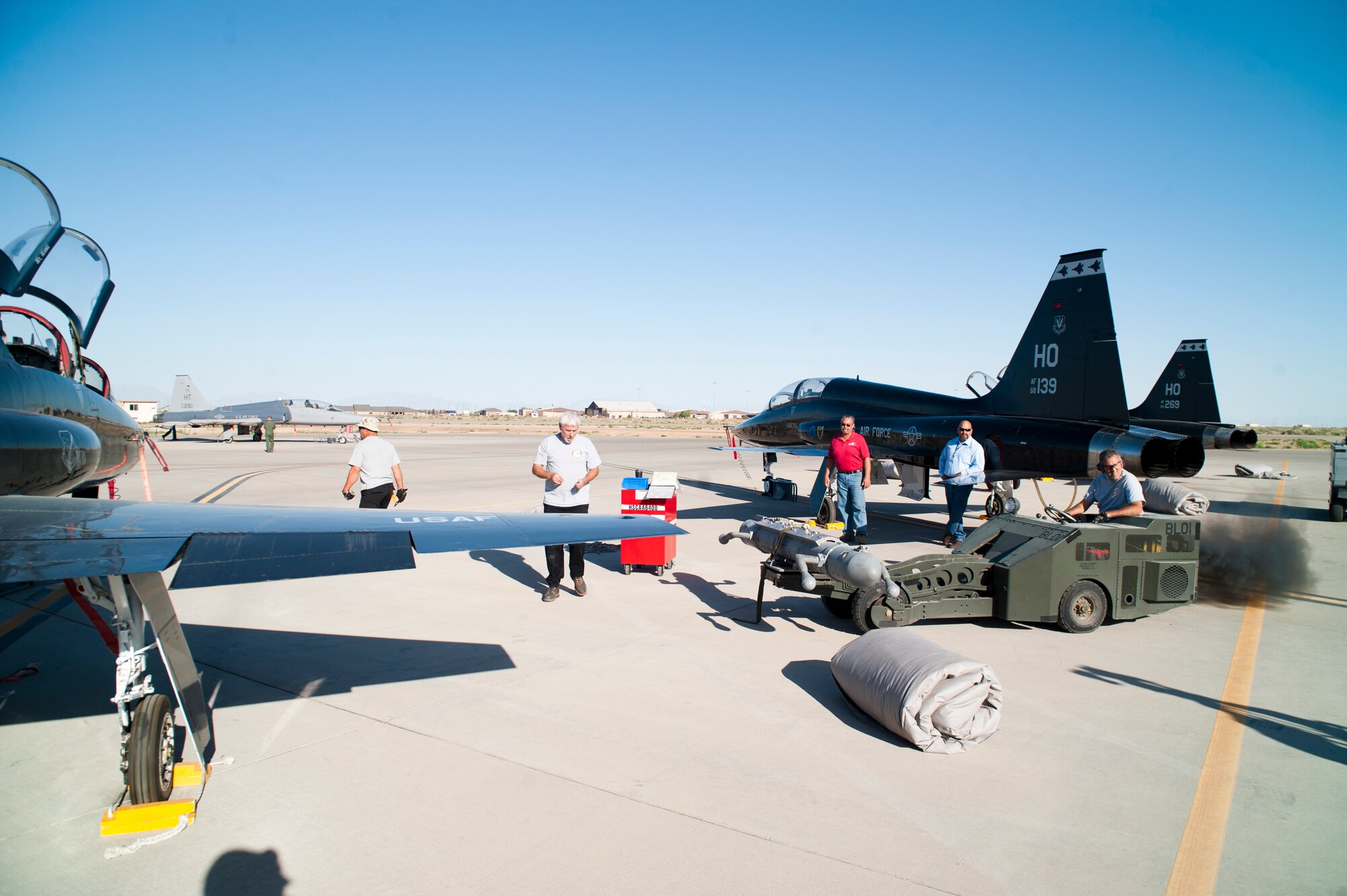 Raul Ceniceros, M1 Support Services maintainer, prepares to load a radar jammer pod onto a T-38 Talon at Holloman Air Force Base, N.M., Jun 4. For the first time, the T-38 has been modified to fit the ALQ-188 pod for use as a radar jammer. This newest addition to the T-38 will assist in its training mission by making it a more effective adversary for the F-22 Raptor during simulated combat exercises. (U.S. Air Force photo by Airman 1st Class Daniel E. Liddicoet/Released)