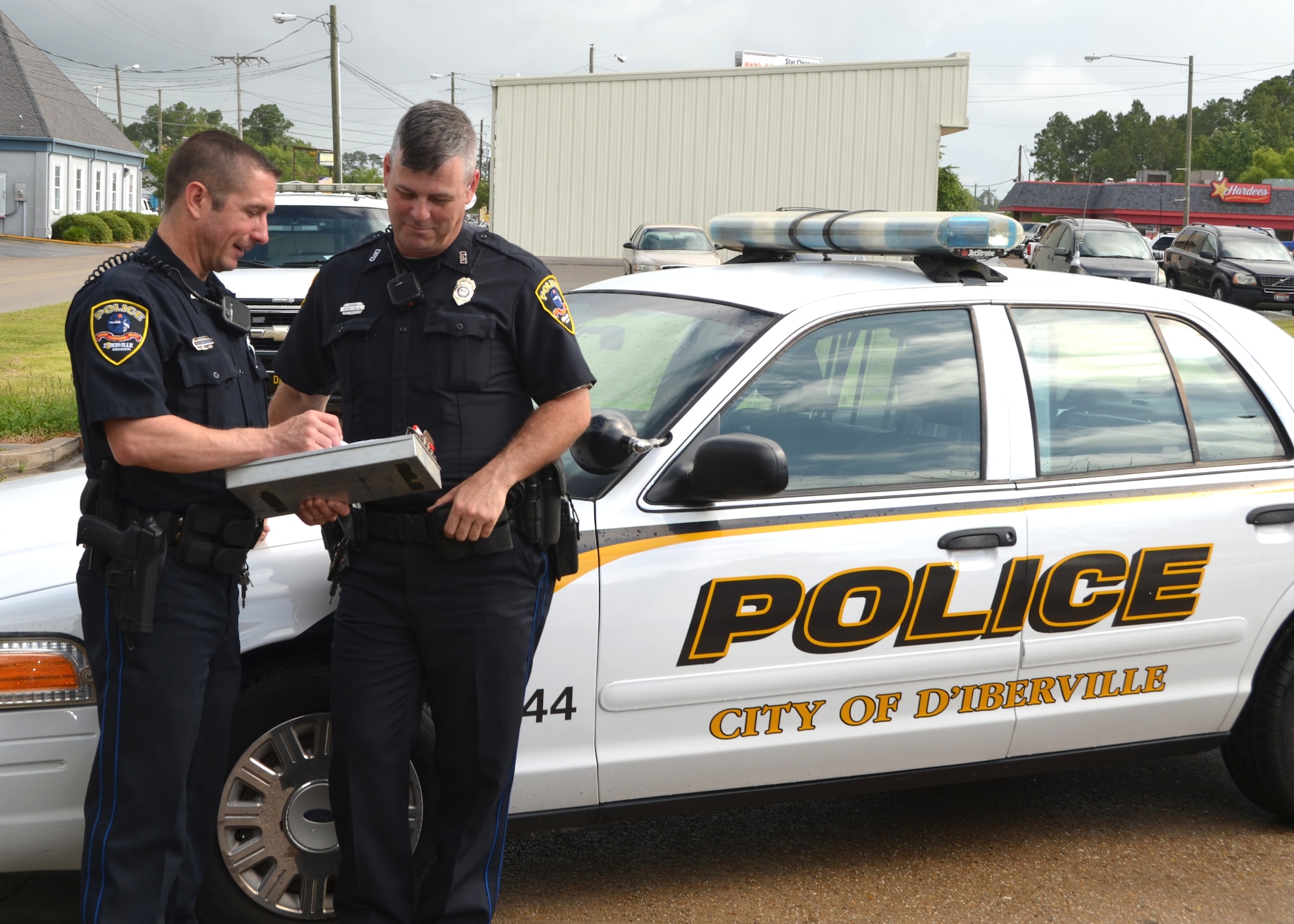 Maj. Troy Kirkbride, left, reviews a report with Master Sgt. Rodney Fisk at the D’Iberville Police Department. Fisk, NCO-in-charge of education and training for the 81st Dental Squadron, has served as a member of the D'Iberville Police Department's Reserve Unit since January 2012 and Kirkbride, 81st Operations Support Flight commander, has been with the D'Iberville PD since it was established in October 2007.
