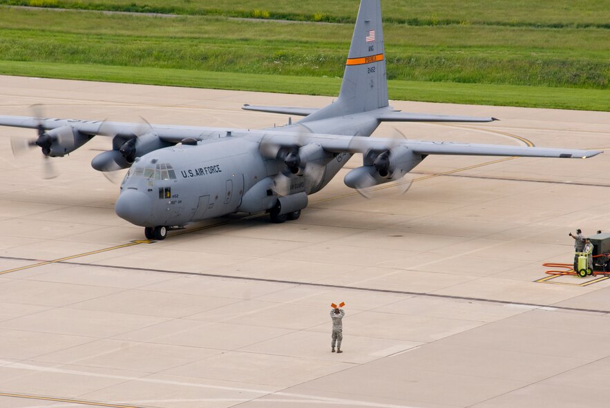 An Illinois Air National Guard C-130H3 Hercules aircraft comes to a stop at the 182nd Airlift Wing apron in Peoria, Ill., June 2, 2013.  The military transport plane participated in a rare seven-ship taxi in which seven aircraft from the Air National Guard base flew together simultaneously in formation.  (U.S. Air National Guard photo by Staff Sgt. Lealan Buehrer/Released)