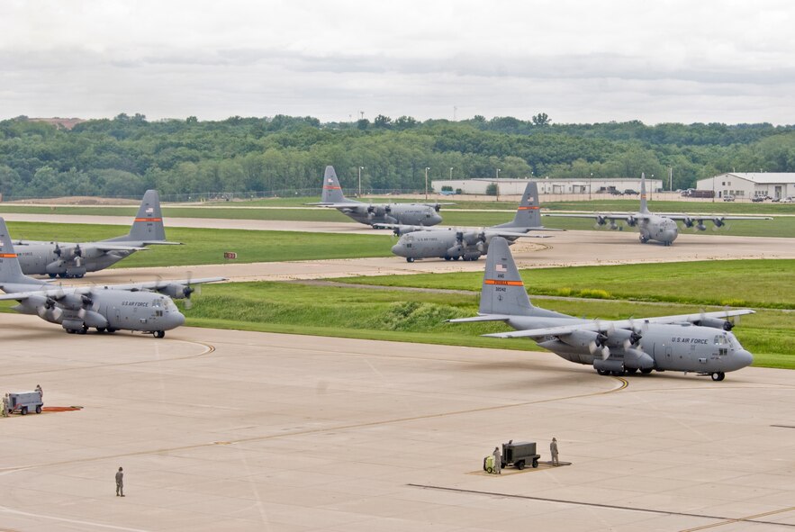 Illinois Air National Guard C-130H3 Hercules aircraft prepare to park at the 182nd Airlift Wing apron in Peoria, Ill., June 2, 2013.  The military transport planes participated in a rare seven-ship taxi in which seven aircraft from the Air National Guard base flew together simultaneously in formation.  (U.S. Air National Guard photo by Staff Sgt. Lealan Buehrer/Released)