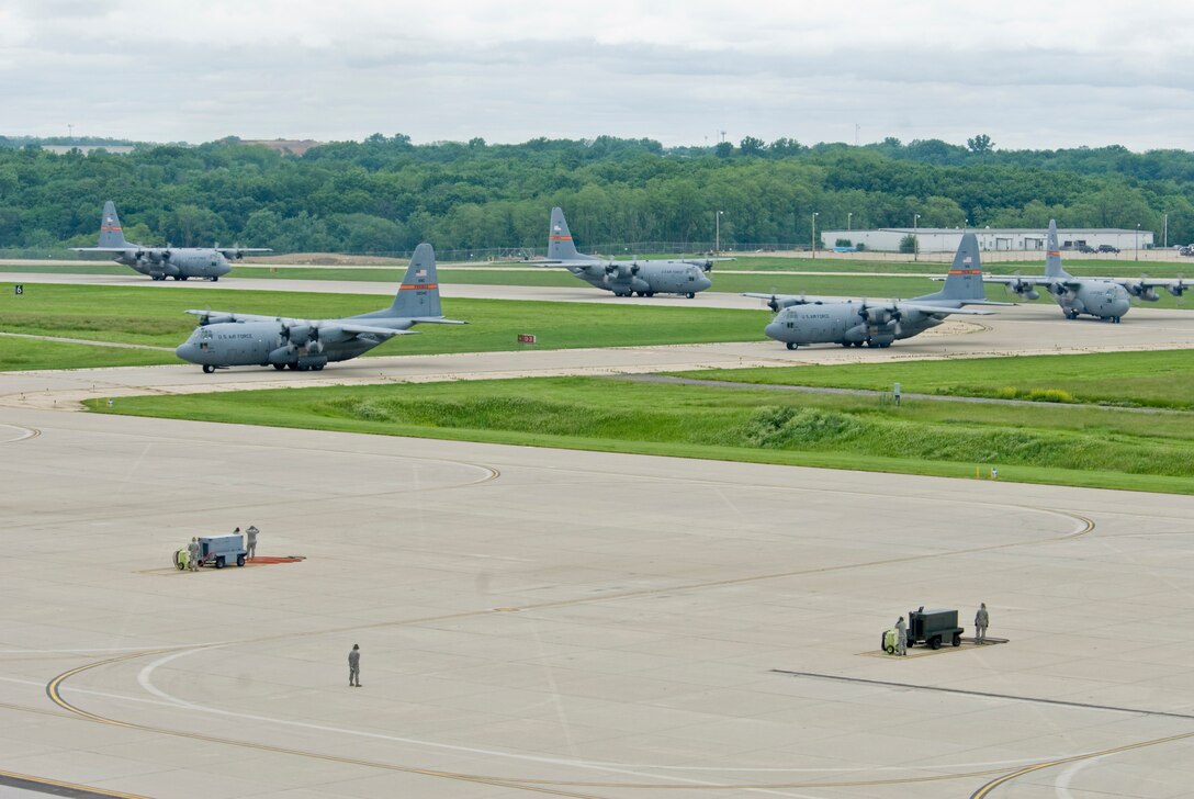Illinois Air National Guard C-130H3 Hercules aircraft enter the 182nd Airlift Wing apron in Peoria, Ill., June 2, 2013.  The military transport planes participated in a rare seven-ship taxi in which seven aircraft from the Air National Guard base flew together simultaneously in formation.  (U.S. Air National Guard photo by Staff Sgt. Lealan Buehrer/Released)