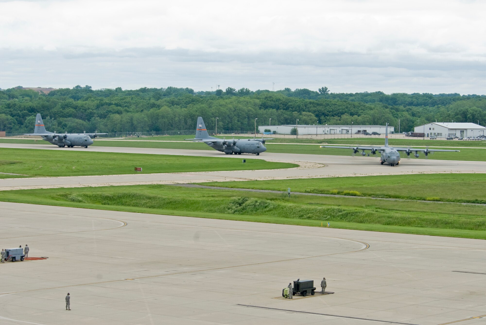 Illinois Air National Guard C-130H3 Hercules aircraft prepare enter the 182nd Airlift Wing apron in Peoria, Ill., June 2, 2013.  The military transport planes participated in a rare seven-ship taxi in which seven aircraft from the Air National Guard base flew together simultaneously in formation.  (U.S. Air National Guard photo by Staff Sgt. Lealan Buehrer/Released)