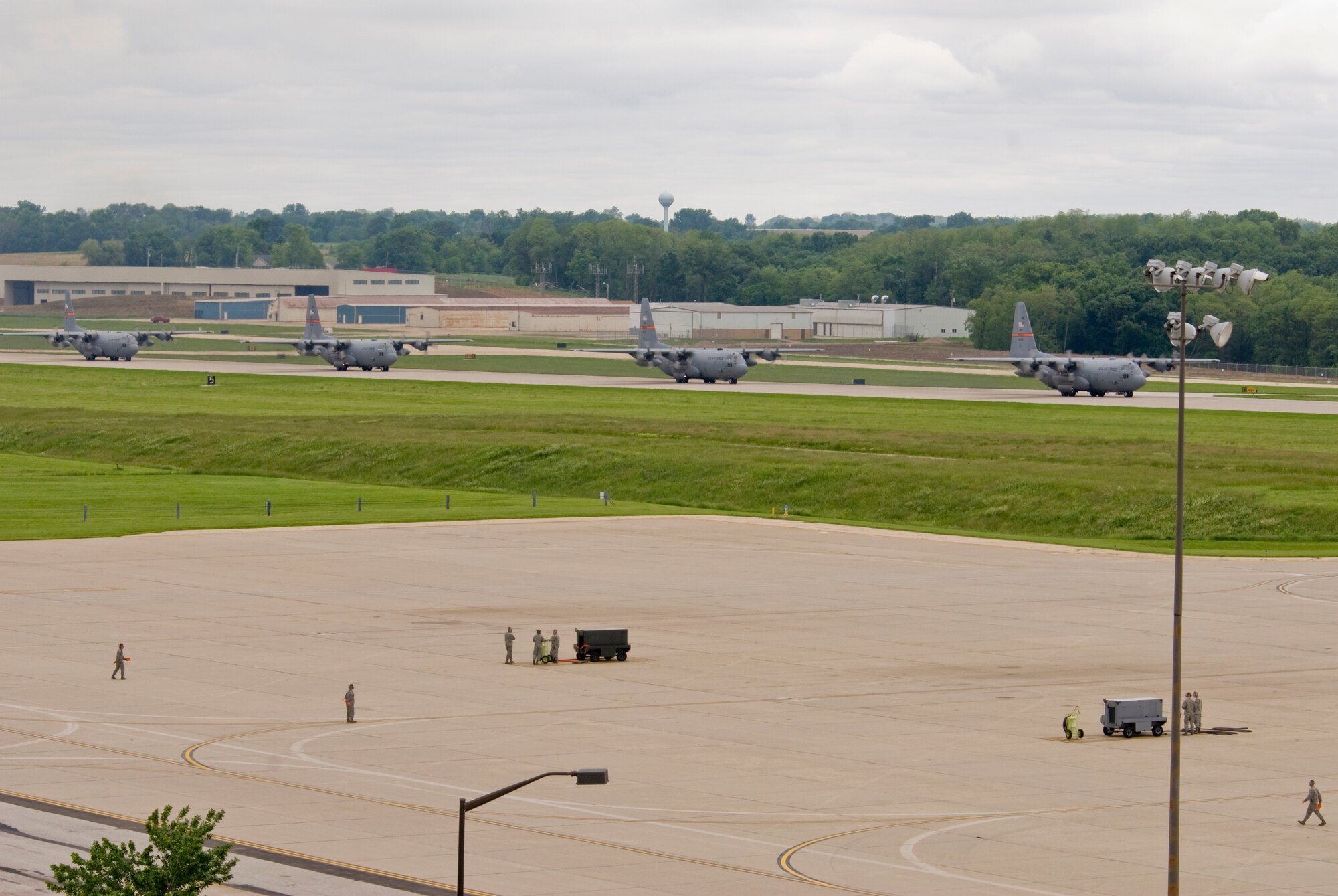 Illinois Air National Guard C-130H3 Hercules aircraft taxi down a runway at the 182nd Airlift Wing in Peoria, Ill., June 2, 2013.  The military transport planes participated in a rare seven-ship taxi in which seven aircraft from the Air National Guard base flew together simultaneously in formation.  (U.S. Air National Guard photo by Staff Sgt. Lealan Buehrer/Released)